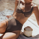 Side Women's espresso high rise bikini bottom in recycled swim fabric